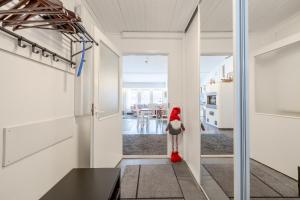 a room with a red object standing in the hallway at Rovaniemi Riverside Family House near Santa Claus Village - Sauna & Aurora View in Rovaniemi