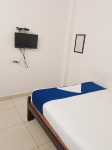 a bedroom with a bed with a camera on the wall at Dreamy beach in Puducherry