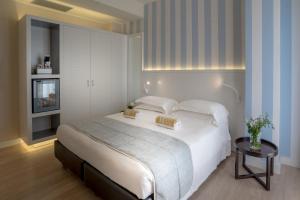 Cama ou camas em um quarto em Hotel Villa Rosa Riviera