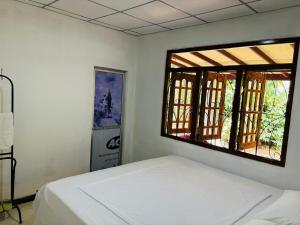 Ένα ή περισσότερα κρεβάτια σε δωμάτιο στο Hideout Deniyaya