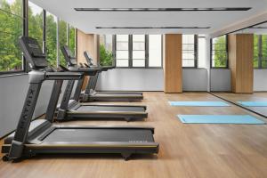 a row of treadmills in a gym with windows at Fairfield by Marriott Shanghai Xuhui Center in Shanghai +12 photos