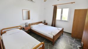 A bed or beds in a room at Ampelos apartment and studios
