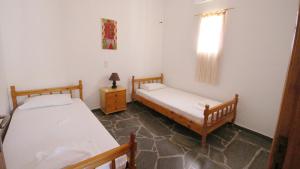 A bed or beds in a room at Ampelos apartment and studios