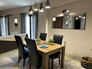 a dining room with a wooden table and black chairs at The Black Chestnut in Áyios Nikólaos