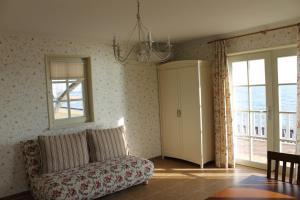 a living room with a couch and a window at Namelis prie marių in Nida