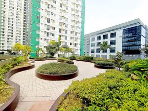 a courtyard with bushes and buildings in a city at 1618T3 Avida Riala IT Park 1BR Unit in Cebu City