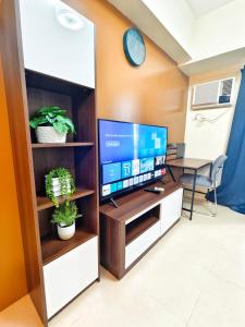 a living room with a tv in a cabinet at 1618T3 Avida Riala IT Park 1BR Unit in Cebu City