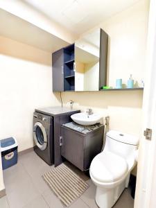 a bathroom with a washing machine and a sink at 1618T3 Avida Riala IT Park 1BR Unit in Cebu City