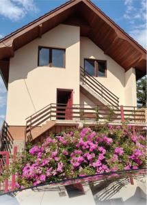 a house with flowers in front of it at Vlajka in Pale +3 photos