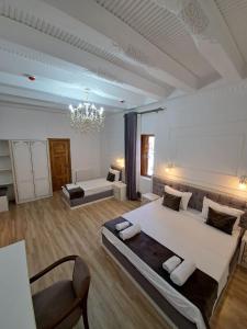 a large bedroom with two beds and a chandelier at NABIBEK TERRACE Ponorama view old city in Bukhara +63 photos