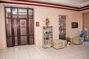 a lobby of a pharmacy with a door and chairs at Hotel Desna in Bryansk