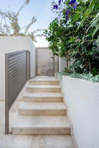 a set of stairs with a gate and flowers at ארץ-נגב צימרים בירוחם in Yeroẖam