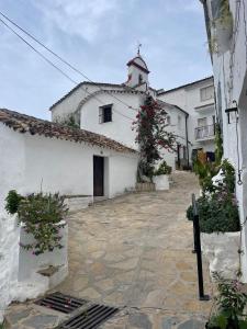 a white building with flowers on the side of it at Petit Suite Alegria in Ubrique
