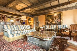 a living room with couches and a table at The Venetian Penthouse in Venice