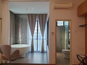 a bathroom with a tub and a sink and a toilet at S Hotel in Johor Bahru +112 photos