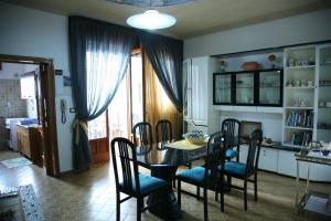 a dining room with a table and chairs at Calì Nitta in Corigliano dʼOtranto