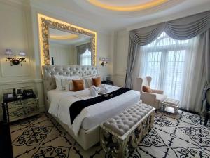 a bedroom with a large bed and a large mirror at Capitol Park By Sahara Hotel in Jakarta