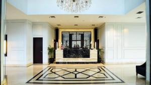 a living room with a chandelier and a lobby at Capitol Park By Sahara Hotel in Jakarta