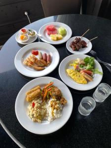 a group of plates of food on a table at Capitol Park By Sahara Hotel in Jakarta