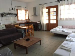 a living room with a couch and a table at Lofos Vourvourou in Vourvourou