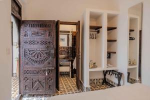 a room with a large wooden door in a room at Riad Dar Irdide in Essaouira