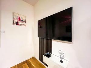 a flat screen tv hanging on a white wall at DAMI in Tuzla