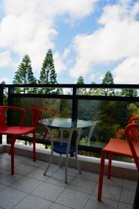 a table and chairs on a balcony with a view at Love Door 168 in Huxi