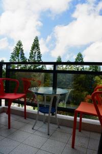 a table and chairs on a balcony with a view at Love Door 168 in Huxi +15 photos