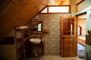 a bathroom with a sink and a mirror on the wall at Doghari Chalets Jibhi by Himtrek Stays in Jibhi