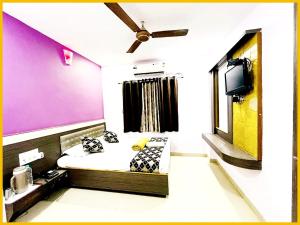 a small room with a bed and a tv at Hotel S B Residency Near Shri Sai Baba Temple - Fully Air conditioned Room - Free Wifi And parking Available - Best Premium Hotel In Shirdi in Shirdi