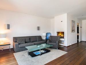 een woonkamer met een bank, een tafel en een open haard bij 6 person holiday home in Skagen in Skagen