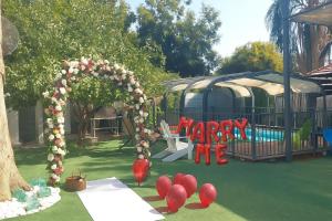 a playground with an arch and a swimming pool at וילה בת גליל יסוד המעלה in Yesod Hamaala