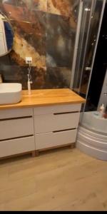 een badkamer met een wastafel en een spiegel en een douche bij Domek na Kaszubach u Doroty  +5 foto's