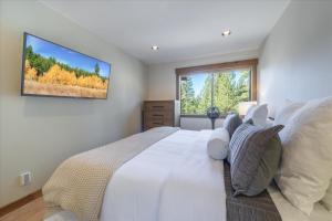 ein Schlafzimmer mit einem großen weißen Bett und einem Fenster in der Unterkunft Indian Hills 6021 townhouse in Truckee-Tahoe Airport
