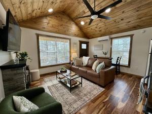 a living room with a couch and a ceiling fan at Alone At Last - New LUX - WiFi - Hot Tub in High Falls