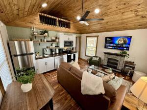 a living room with a couch and a table and a kitchen at Alone At Last - New LUX - WiFi - Hot Tub in High Falls +20 photos