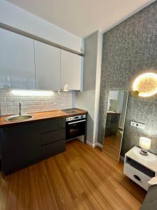 a kitchen with a sink and a counter top at Вид на закат, море и бассейн in Batumi