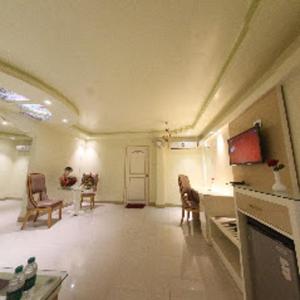 a large room with chairs and a table and a door at HOTEL SAPTARSHI in Bānkura