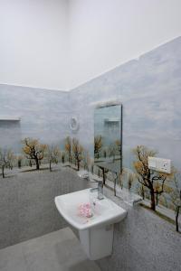 a bathroom with a sink and a mirror at Sun Side Villa in Ginimellagaha West