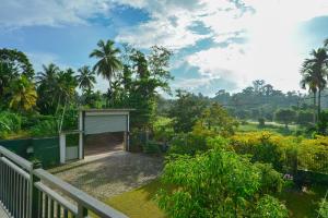 a gate to a garden with a garage at Sun Side Villa in Ginimellagaha West