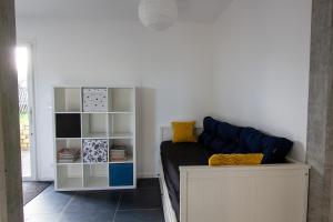 a bedroom with a bed and a book shelf at Appartement Neuf - Port de l'AberWrac'h - in Landéda