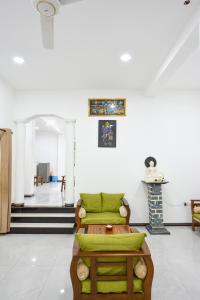 a room with two green beds and a fireplace at Sun Side Villa in Ginimellagaha West