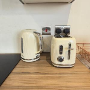 two toasters sitting on top of a counter at Stylish Apartment in Bradford