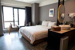 a bedroom with a bed and a mirror and a sink at hotel No25 in Incheon