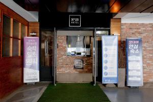 an open door with signs in front of a building at hotel No25 in Incheon