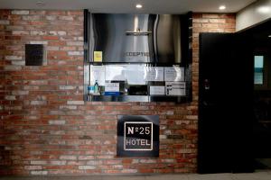 a sign on the side of a brick wall at hotel No25 in Incheon +15 photos