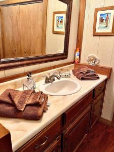 a bathroom with a sink and a mirror at Romantic and Rustic Cabin Rental for Couples in Bitterroot Valley, Montana in Hamilton
