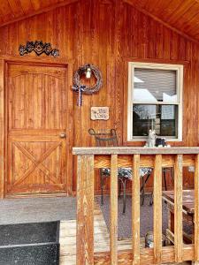 a wooden cabin with a table and a door at Romantic and Rustic Cabin Rental for Couples in Bitterroot Valley, Montana in Hamilton