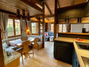 a kitchen and living room with a table and a couch at Gstaad Chalet in Gstaad