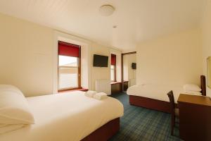 a hotel room with two beds and a window at The Anchorage in Troon